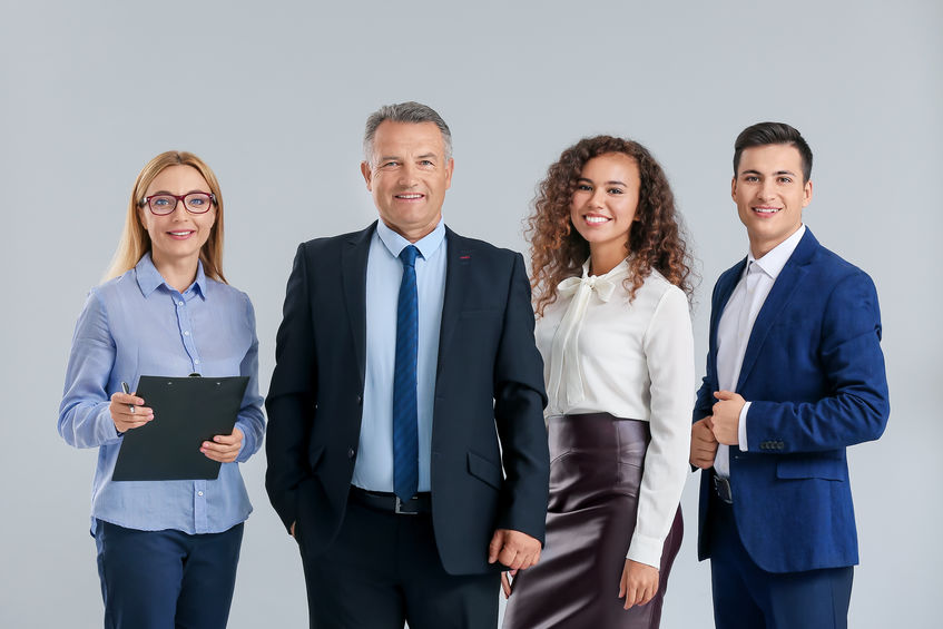 Portrait of business people on grey background